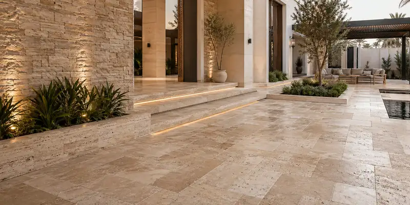 Natural stone floor and wall installation in a Dubai villa courtyard transition space